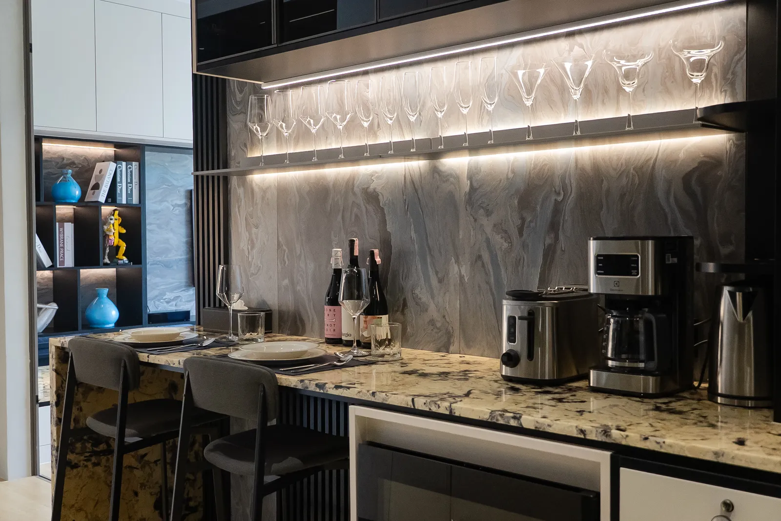 Kitchen bar with backlit glassware wall