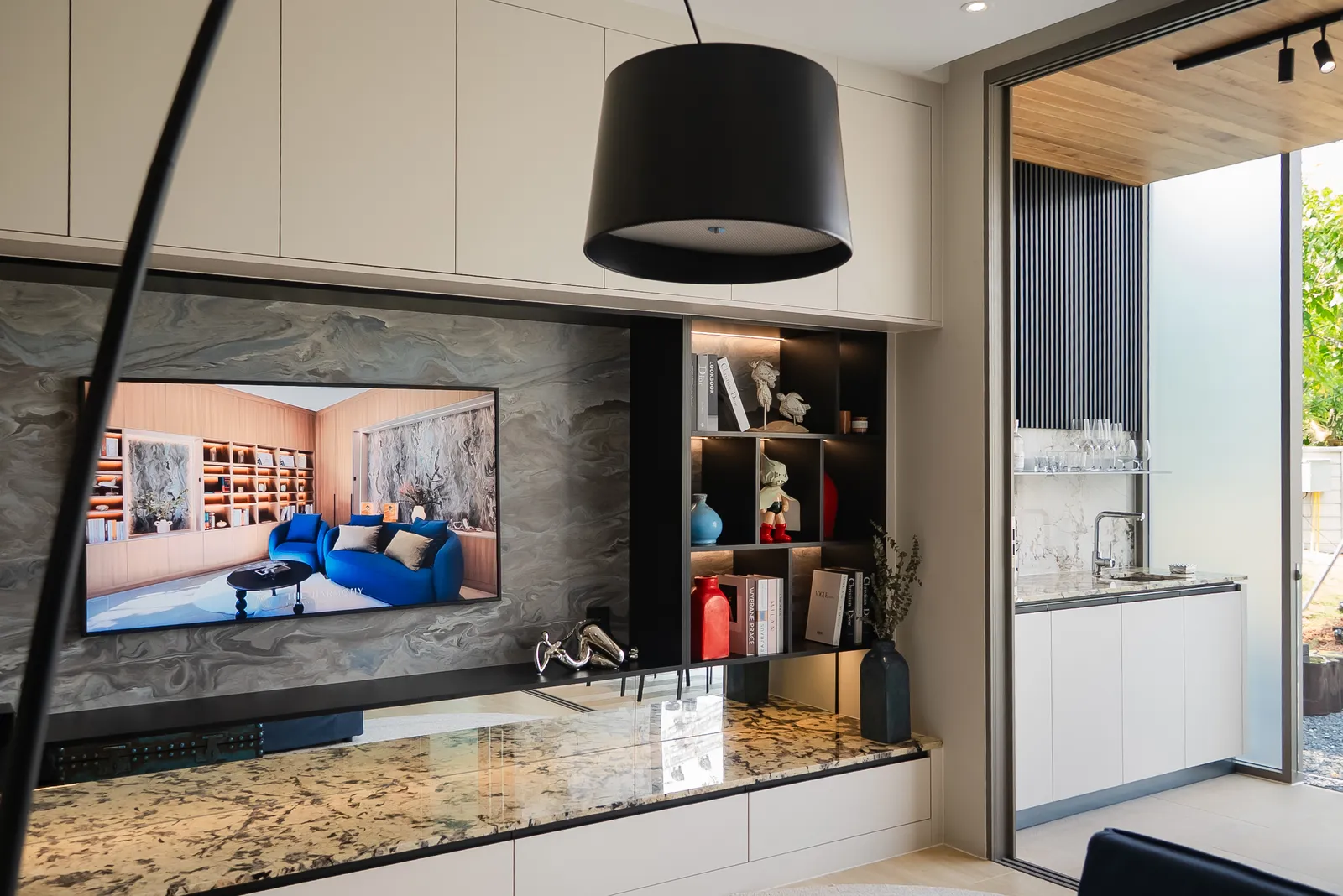 Living area with media wall and terrace access