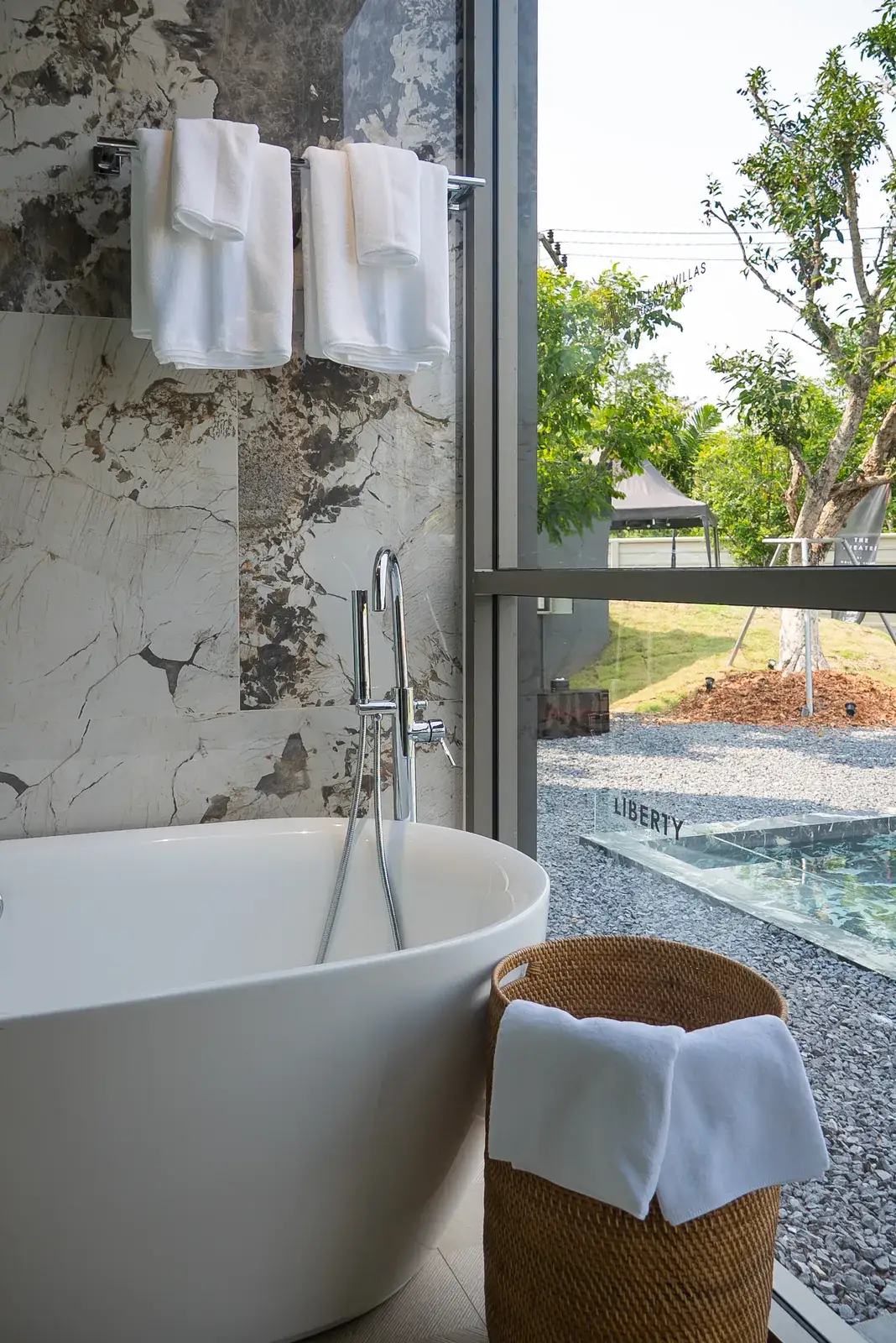 Freestanding bathtub with a garden view